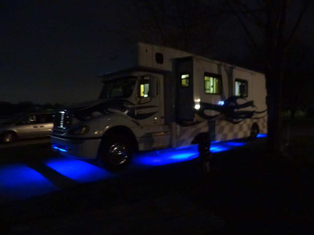 Blue at night with the undercarriage lights on.