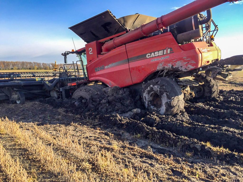 A combine, VERY much stuck in the mud.